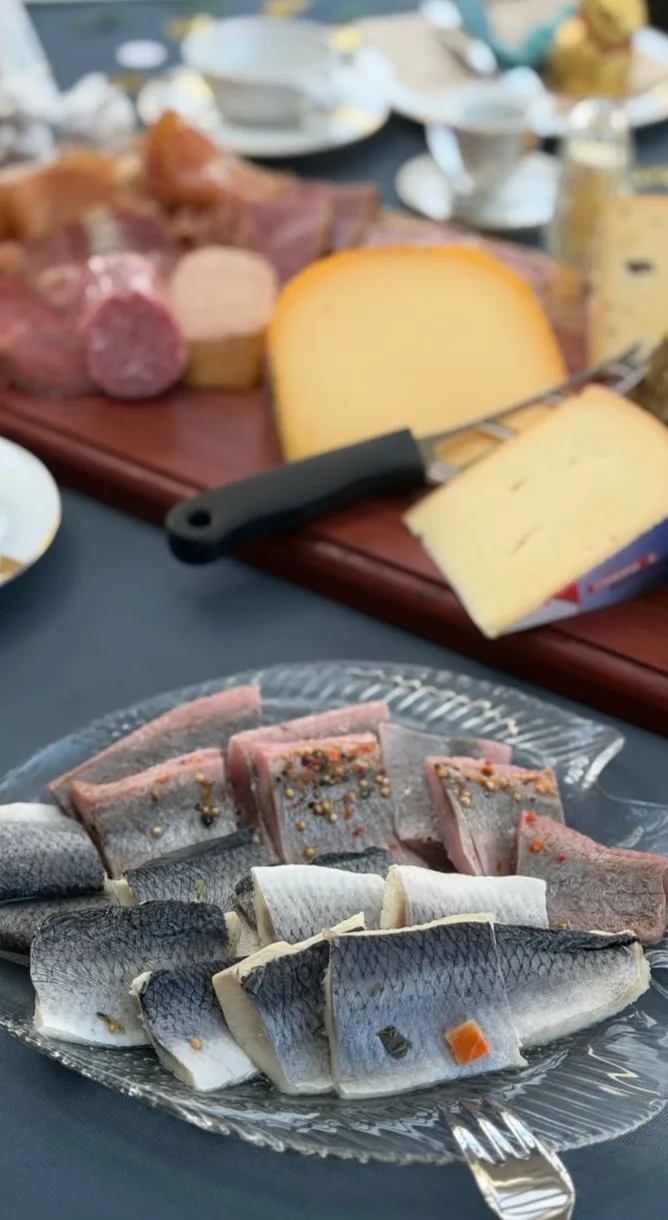 Cured herring with pepper and capsicum, alongside a charcuterie and aged-cheese board